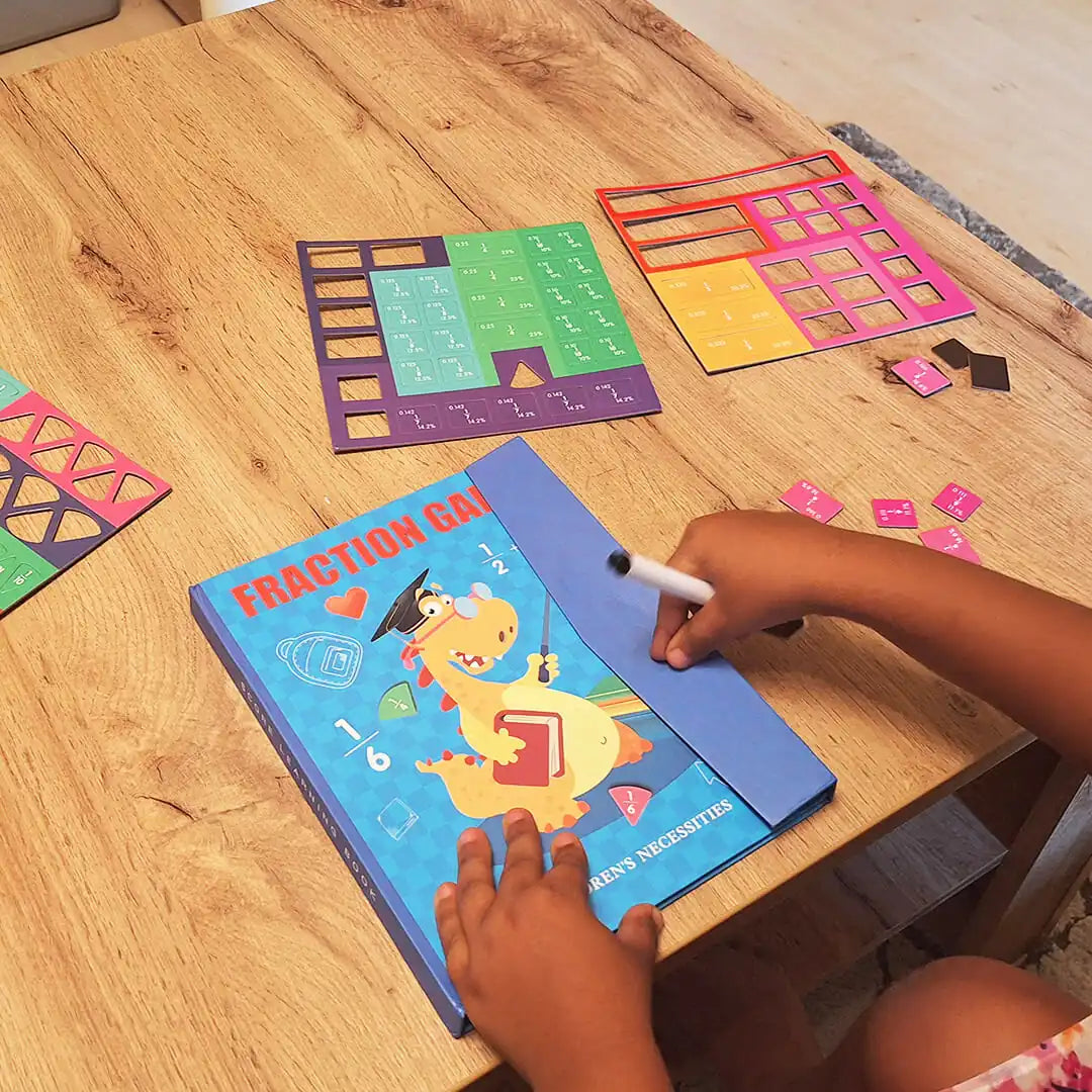 Child exploring the FractionHero learning set with magnetic fraction tiles and marker – a fun, hands-on way to understand fractions visually.