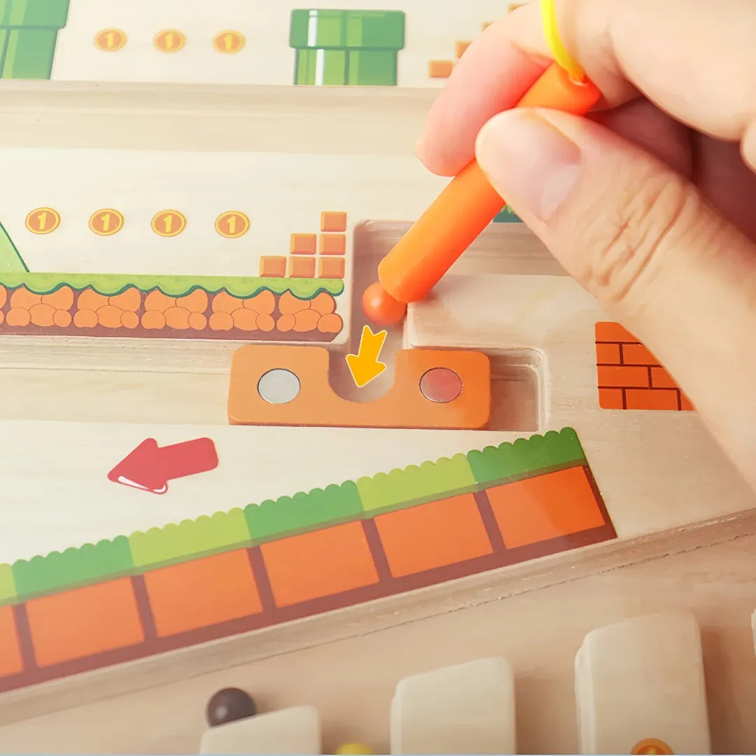 Child using magnetic stylus to guide ball through wooden maze board – supports fine motor skills, logical thinking and interactive number play.