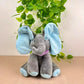 Interactive grey elephant plush toy with soft blue ears and feet, wearing a purple polka-dot scarf – perfect for cuddles, music and peek-a-boo fun.