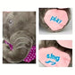 Close-up of the interactive Cuddlephant toy showing embroidered “sing” and “play” buttons on its pink feet and its soft grey trunk with a purple polka-dot scarf – designed for sensory and musical engagement.