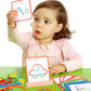 Child exploring ShapeCraft with colourful shape pieces and activity cards at a green table