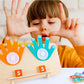 Child using TallyTots wooden number board with colourful felt hands to learn counting and number recognition through hands-on play
